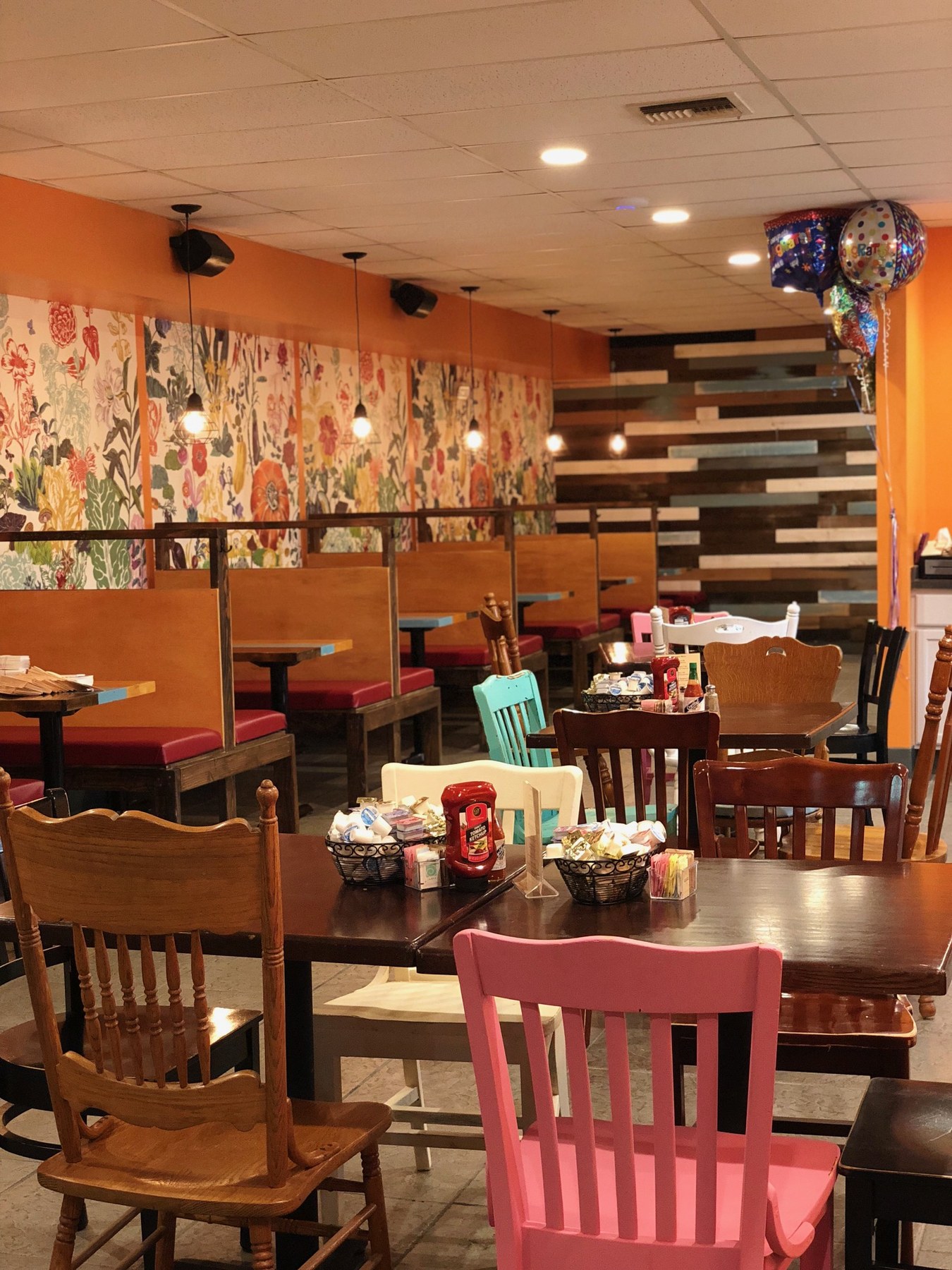 Wide view of the dining room tables and chairs, ready for guests