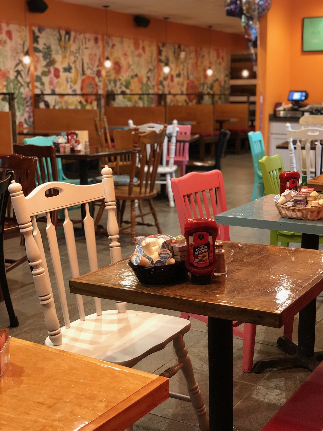 Dining table set with condiments in the colorful painted-chair dining room